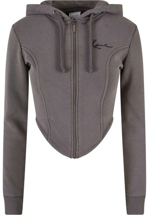 Grey cropped hoodie made of soft fabric, featuring a zip front, drawstring hood, long sleeves, and curved seams for a fitted design.