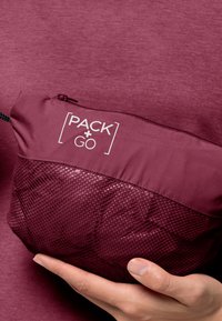 Burgundy travel pouch with a smooth upper section and mesh lower section. Features "PACK + GO" text and a zipper closure. Hand-held.