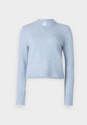Light blue cropped sweater made of soft fabric. Features a V-neckline and ribbed cuffs and hem for added texture.