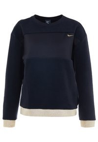 Nike sininen fleecesweatshirt, jossa on kultainen logo. Sisältää lohkoväri-muotoilun, pitkät hihat sekä kultaisella viimeistelyllä varustetut helmassa ja hihansuissa.