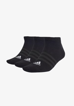 Conjunto de calcetines deportivos negros, que presenta un puño acanalado, un diseño clásico a rayas y un logo blanco en el lateral, fabricados con una tela suave y elástica.