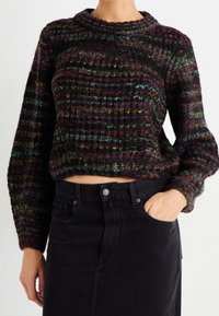 Textured, multicolored cropped sweater with a ribbed design in dark hues and pops of green, red, and blue. Long sleeves and a rounded neckline.