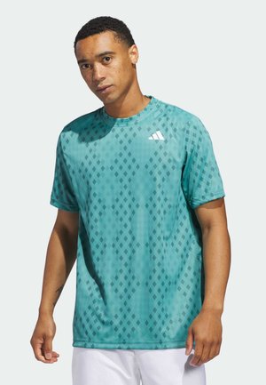 Turquoise athletic t-shirt with a diamond pattern, short sleeves, crew neckline, and small white logo on the left chest. Soft fabric texture.