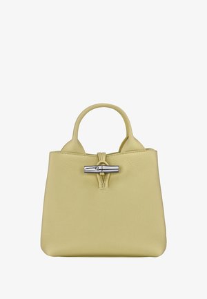 Yellow leather handbag with a textured finish, featuring a top handle and a silver toggle closure at the front. Compact and structured design.