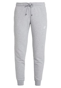 Jogging en coton gris avec une taille à cordon, poignets fuselés et un petit logo blanc sur la cuisse gauche. Texture douce, design décontracté.