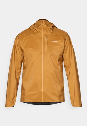 Waterdichte, met capuchon geklede jas in een warme bruine kleur. Voorzien van een volledige rits, lichtgewicht stof en een borstzak. Merkenlogo aan de voorkant.