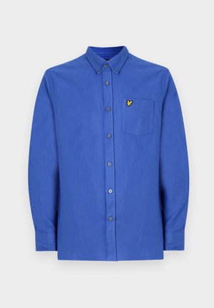 Zila garām piedurknēm apģērbs, kas izgatavots no gludas auduma, ar pogu apkakli, priekšējiem pogām, krūšu kabatu un dzeltenu logo detaļu.