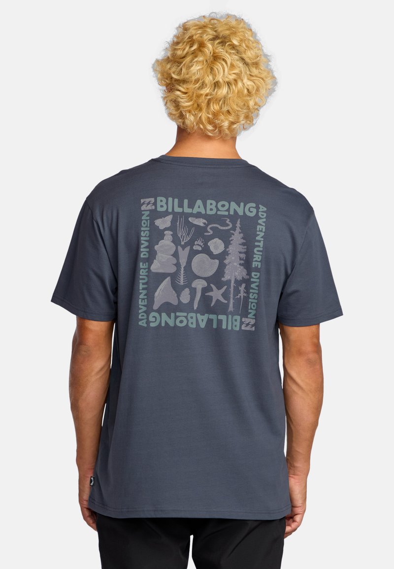 Navy blue short-sleeve t-shirt with a graphic print on the back featuring abstract nature-themed illustrations and "BILLABONG" text.