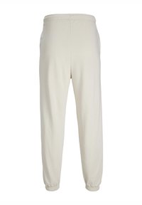 Lys beige sweatpants lavet af bomuld, med elastisk talje og tapered cuffs, med en glat overflade og uden synlige mønstre.