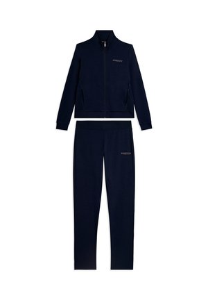Tuta blu navy con giacca con zip integrale e pantaloni abbinati, entrambi con marchio "FREDDY" sul petto e sulla coscia.