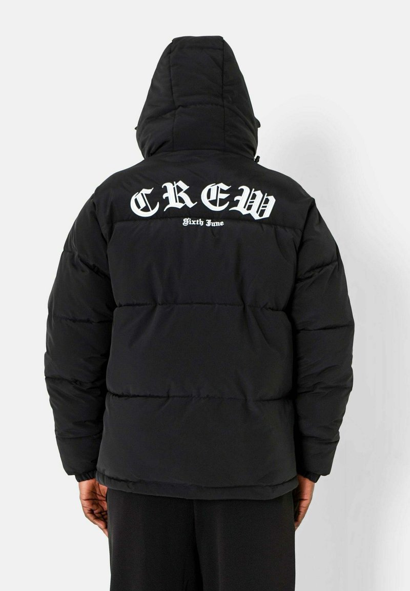 Zwarte pufferjack met een capuchon, voorzien van grote witte tekst "CREW" en "Sixty June" op de bovenrug, gestikte textuur en een losse pasvorm.
