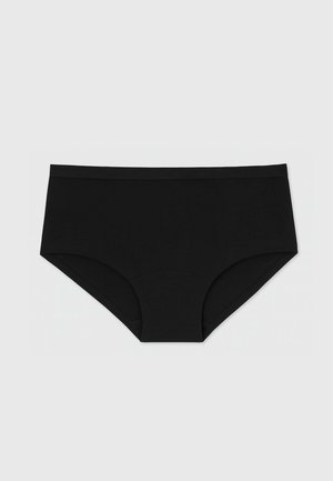 Slip in cotone nero con un design a vita media, morbido elastico in vita e tessuto liscio senza cuciture visibili. Superficie semplice.