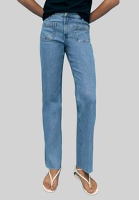 Light blue straight-leg jeans made of denim, featuring five pockets, a zipper fly, and a raw hem. Paired with white flip-flops.