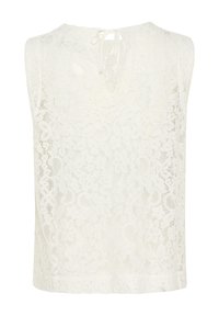 Haut sans manches en dentelle blanc cassé avec des motifs floraux, un col rond et un lien de fermeture à l'arrière. Tissu doux et texturé.
