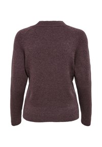 Brun stickad tröja med rund halsringning, långa ärmar och en slät struktur. Har en figursydd silhuett och ribbad fåll.