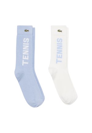 Coppia di calzini al ginocchio, uno azzurro chiaro e uno bianco, ciascuno con testo "TENNIS" e piccolo logo verde del coccodrillo vicino alla parte superiore.