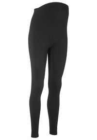 Leggings noirs ajustés avec une taille élastique, fabriqués en tissu extensible, présentant une texture lisse et sans coutures ni motifs visibles.