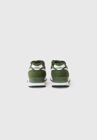 Green athletic shoes with a padded collar, mesh panels, white accents, and a black rubber sole, showing a rear view.