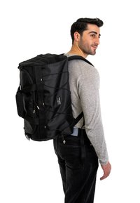 Black fabric backpack with a rectangular shape, featuring adjustable straps, a front bungee cord, and zippers. Simple design, medium size.