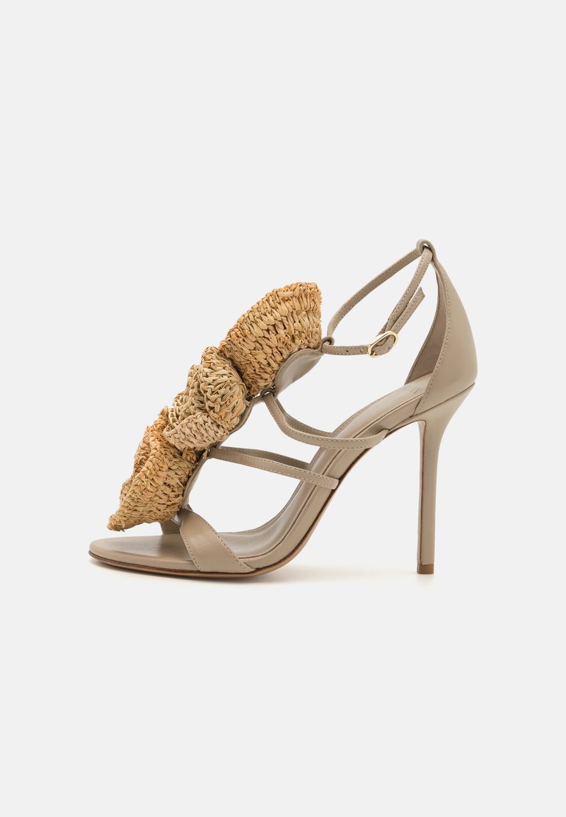 Beige stiletto sandal featuring a woven straw accent on the front, with strappy design and closed back. Smooth leather upper and sole.