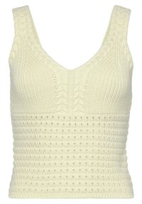 Knitted sleeveless top in soft cream, featuring a V-neck, textured cable and dotted patterns, with a close-fitting silhouette.