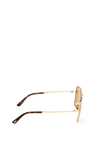 Guldmetallssolglasögon med bruna tonade linser och skalm med sköldpaddsmönster. Slankt utförande med en modern geometrisk form.