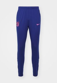 Sötétkék sportnadrág sima poliészterből. A bal combján pink Nike logó és pink pajzs embléma található. Szűkülő kialakítás.