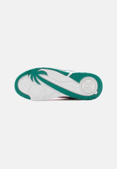 Πάτος αθλητικού παπουτσιού με πράσινο και λευκό πέλμα, που διαθέτει σχέδιο φοίνικα και κυκλικό λογότυπο κοντά στη φτέρνα.