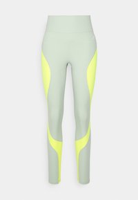 Leggings a vita alta in tessuto verde chiaro con pannelli laterali a contrasto in neon giallo. Texture liscia e design aderente per un utilizzo attivo.