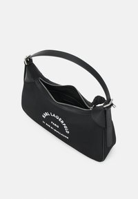 Black Karl Lagerfeld shoulder bag with silver zipper, single strap, and white logo text on front.