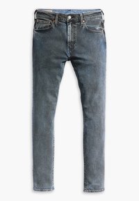 Blå denimjeans med smal passform, utrustade med framfickor, dragkedja och kontrasterande sömmar. Tyget har en texturerad yta.