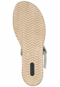 Semelle de sandale avec motif en chevrons. Caoutchouc beige clair avec logo de la marque en relief et taille. Semelle intérieure rembourrée et brides ajustables.
