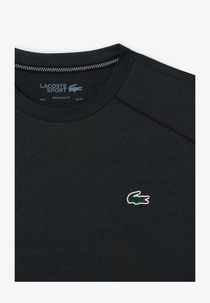 Black Lacoste Sport t-shirt in regular fit, featuring a small green crocodile logo. Made from smooth fabric with a round neckline.