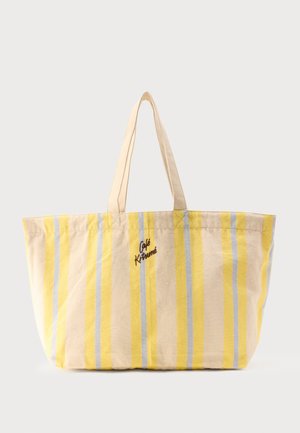 Stor beige tote taske med lodrette gule og lyseblå striber og "Café Kitsuné" broderet foran, med to beige håndtag.