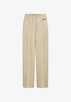 Bež široke hlače z elastičnim pasom, vrvico za zategovanje, sprednjimi gubami in majhno oznako "Karl Lagerfeld Jeans" na desnem boku.