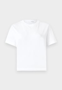 T-shirt blanc uni à manches courtes et col rond, coupe régulière, présenté sur un fond gris neutre.