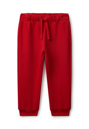 Helle rote Baumwoll-Jogginghose mit elastischem Bund, Kordelzug und gerippten Bündchen auf einem weißen Hintergrund.