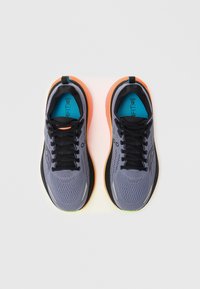 Gray athletic shoes with black laces, orange midsole, and textured mesh upper. Features a blue insole and black outsole.