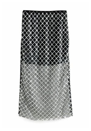 Black and sheer skirt featuring a floral pattern with silver accents. The design includes a flowing, layered silhouette.