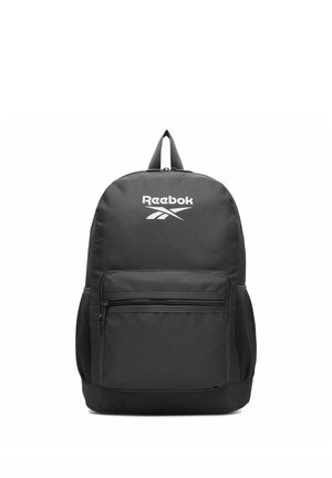 Black Reebok backpack with a front zip pocket, mesh side pockets, and a top handle against a white background.