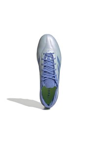 Light blue soccer shoe with a glossy upper, featuring three darker blue stripes, a lace closure, and a green insole. Lightweight design.