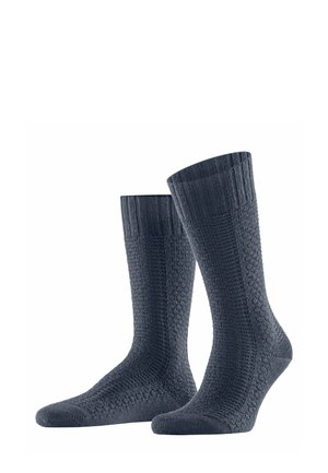 Dunkelnavyfarbene Socken mit gerippten Bündchen und einem strukturierten Muster über die gesamte Sockenfläche. Hergestellt aus einem weichen, dehnbaren Material, das für Komfort sorgt.