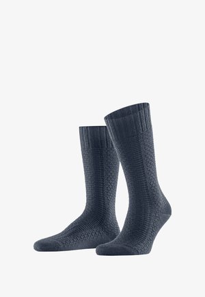 Calze di colore blu navy scuro con polsini a coste e un motivo testurizzato su tutta la superficie. Realizzate in un materiale morbido ed elastico, progettate per il comfort.