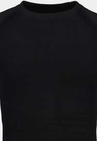 Black fitted long-sleeve shirt made of ribbed fabric, featuring a crew neckline and seamless shoulder design. Smooth texture with minimal detailing.
