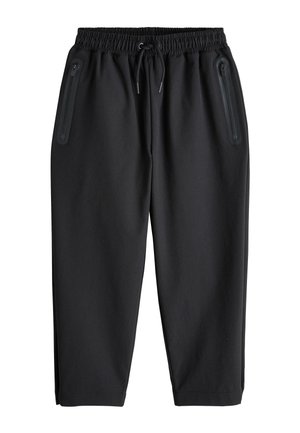 Sorte afslappede bukser med elastisk talje og snøre samt to lodrette lynlåslommer foran, vist på hvid baggrund.