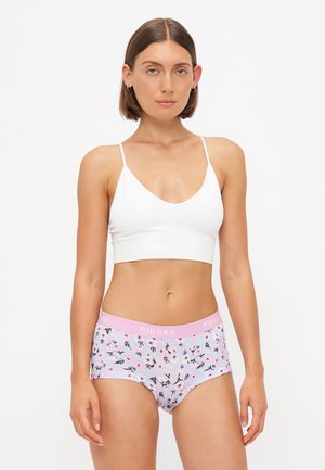 White ribbed bralette and pink, floral-patterned hipster briefs with a soft waistband labeled "PIECES." Smooth fabric with a light texture.
