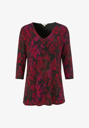 V-pääntie paita, joka on valmistettu kevyestä kankaasta ja jossa on punaisia ja vaaleanpunaisia kukkakuosisia yksityiskohtia mustalla taustalla. Paidassa on kolmennesosrannekeet.