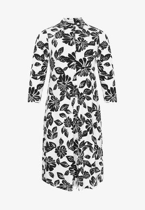 Vestido blanco de manga larga con estampado floral y de hojas negras, cierre frontal con botones y cuello.