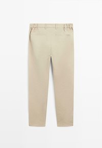 Beige cotton trousers with a relaxed fit, featuring an elastic waistband, two back pockets, and a smooth texture. Plain design, no patterns.