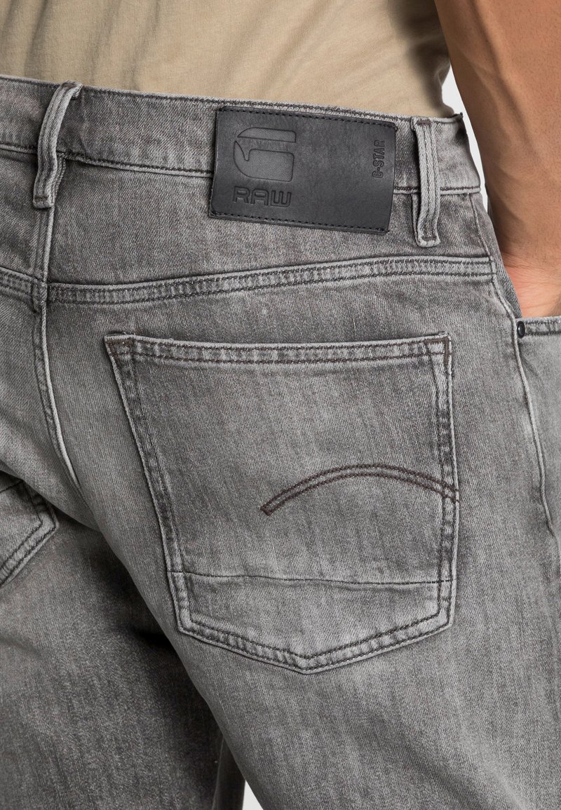 Herren Skinny Fit | G-Star TRIPLE A STRAIGHT Jeans Straight Leg burten black stretch denim faded carbon/grey denim - YO43095 Herren Skinny Fit | G-Star TRIPLE A STRAIGHT Jeans Straight Leg burten black stretch denim faded carbon/grey denim - YO43095